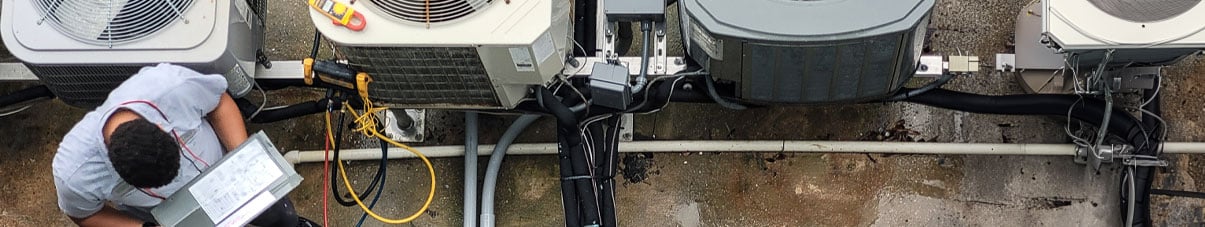 AC installer checks compressor units