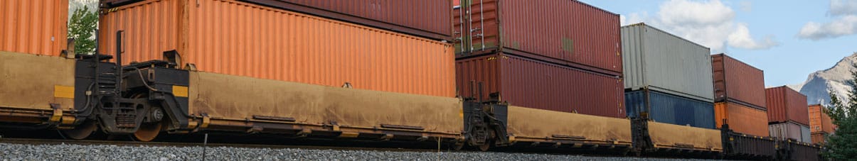freight stacked along a train route
